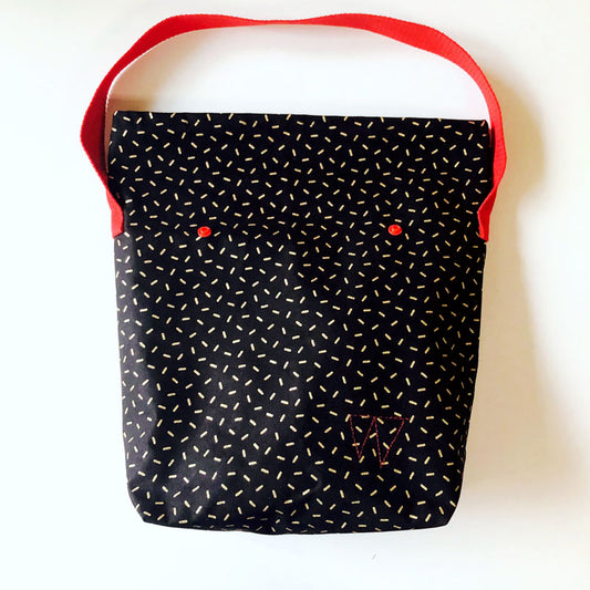 Lunch bag enduit noir à motifs dorés