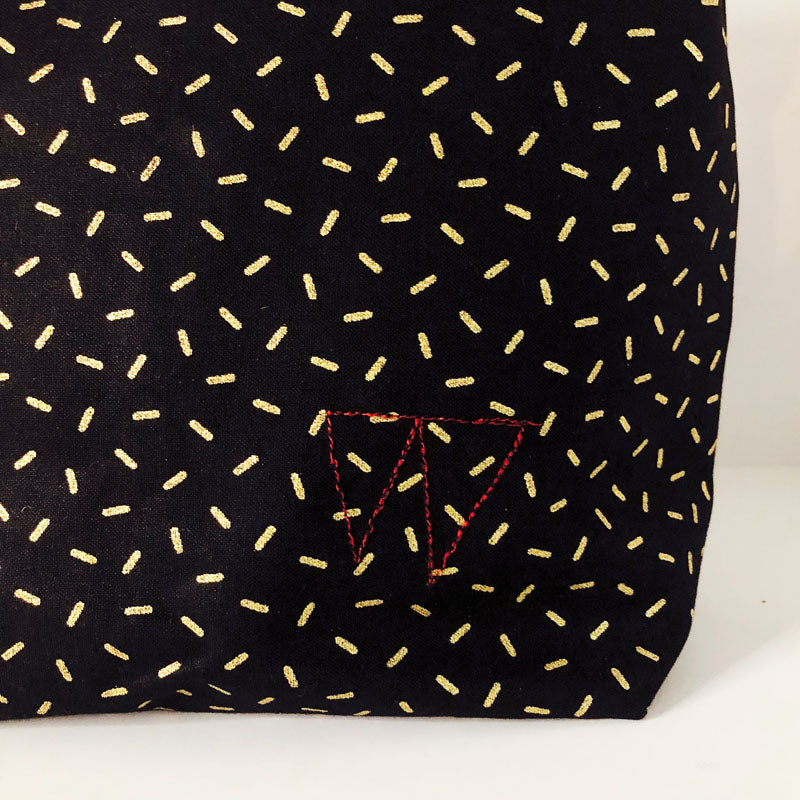 Lunch bag enduit noir à motifs dorés